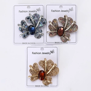 Close-up of butterfly brooch with rhinestones in blue, purple, and amber finishes