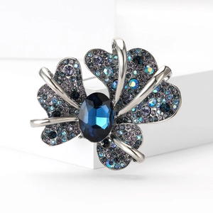 Elegant silver butterfly brooch with deep blue center stone and sparkling crystals
