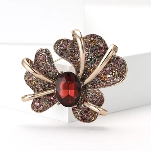 Vintage gold butterfly brooch with large red gemstone and colorful sparkling rhinestones