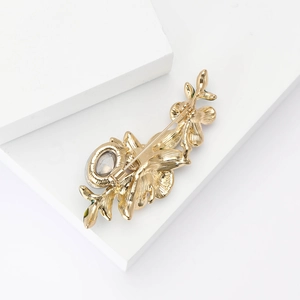 Elegant gold iris flower brooch with enamel petals and textured metal floral details