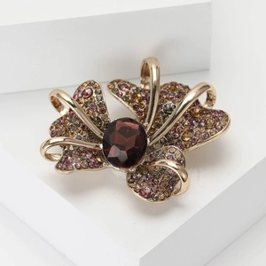 Vintage gold bow brooch with sparkling colorful rhinestones and deep red center stone