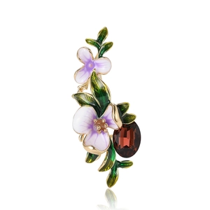 Elegant iris flower brooch with purple enamel petals and oval red gemstone in gold finish