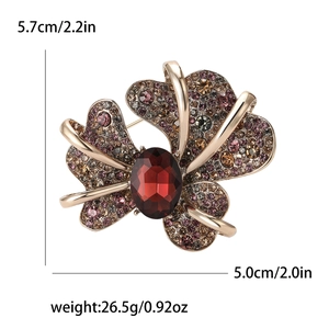 Vintage iris flower brooch with rhinestones and ruby red stone centerpiece for women