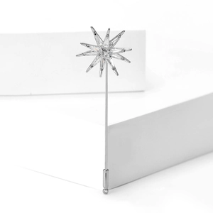 Detail view of silver eight-point star brooch with micro-paved cubic zirconia crystals
