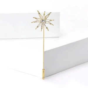 Elegant gold-tone eight-pointed star brooch with cubic zirconia crystals on long pin