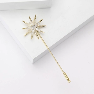 Elegant gold-tone eight-pointed star brooch with cubic zirconia on white geometric stone