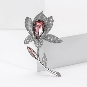 Elegant silver lily brooch with micro-set zircons and pink teardrop crystal center