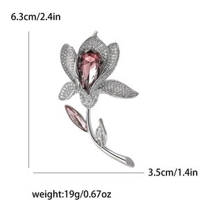 Elegant lily flower brooch with pink crystals and cubic zirconia set in silver metal