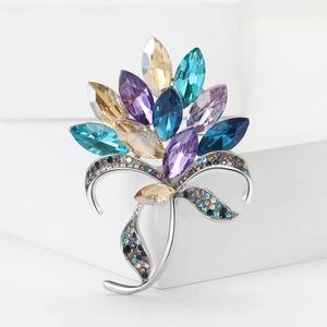 Detailed close-up of a floral alloy brooch with colorful marquise rhinestones and silver stems