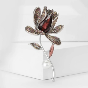 Elegant lily flower brooch with red pear-cut crystal, pink pavé petals, and white pearl