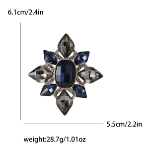 Detailed view of vintage starburst brooch with blue crystals and size specifications