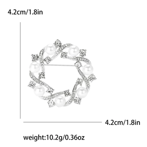 Detail view of pearl and rhinestone wreath brooch with 4.2cm size and 10.2g weight specs