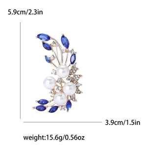 Detailed view of crescent flower brooch with white pearls and blue marquise stones