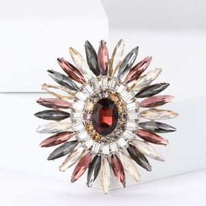 Dettaglio della spilla a girasole con gemma rosso scuro e cristalli marquise colorati