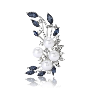 Elegant silver flower brooch with white pearls, blue gemstones, and sparkling zircons