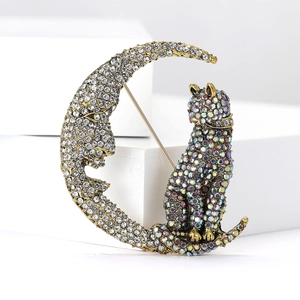 Close-up of cat and moon brooch with intricate rhinestones and shimmering vintage finish