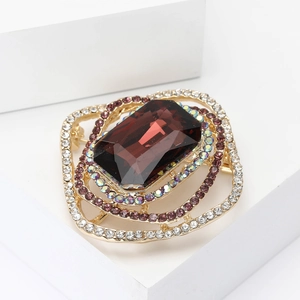 Elegant gold square brooch with large brown crystal and rhinestone accents on white display