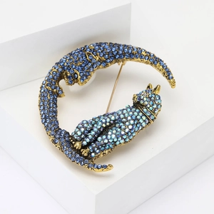 Exquisite gold-plated crescent brooch with navy and light blue rhinestone twin cats