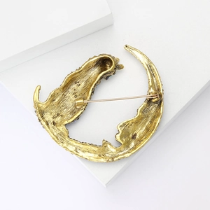 Detailed back view of a vintage moon cat brooch with secure long pin fastener mechanism
