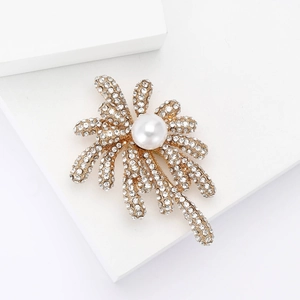 Exquisite fireworks brooch with a large white pearl and sparkling crystals on golden alloy