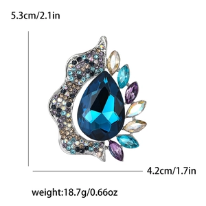 Detail showing dimensions of rhinestone brooch with pear-shaped blue stone and colorful gems