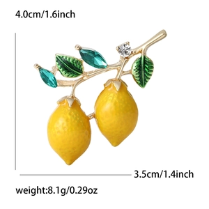 Chic yellow enamel lemon branch brooch with green leaves and crystals on a white background