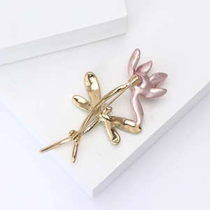 Macro detail of pink lotus brooch with golden pin backing and smooth enamel petals