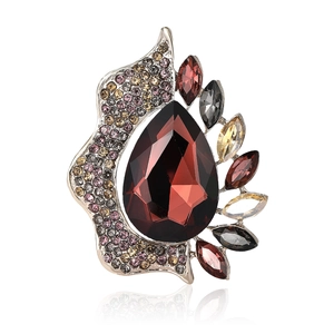 Elegant vintage alloy brooch with a large pear-shaped red gemstone and sparkling rhinestones