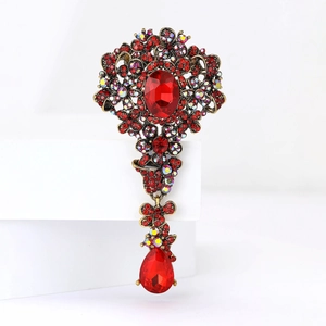 Spilla vintage con strass rossi, design floreale in bronzo e pendente a goccia