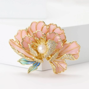 Close-up of pink enamel peony flower brooch with white pearl and sparkling zircons