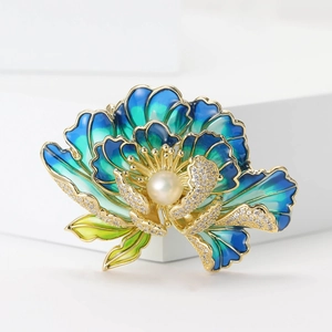 Detail view of peony brooch with blue enamel petals, central pearl and cubic zirconia