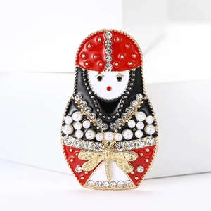 Exquisite rhinestone Matryoshka doll brooch with red enamel and pearl accents on suit jacket