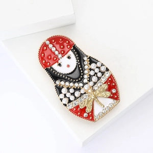 Exotic Russian Nesting Doll brooch with rhinestones and pearls on white background