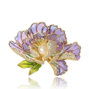 Elegant gold-tone peony brooch with purple enamel petals, pearl center and crystals