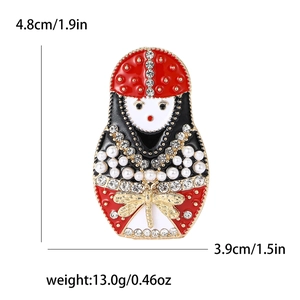 Russian nesting doll brooch with rhinestones and enamel, measuring 1.9 by 1.5 inches