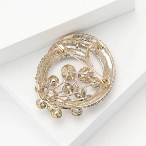 Detailed back view of a gold hot air balloon brooch showing security pin and rhinestones