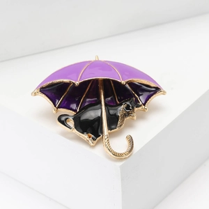 Cute enamel umbrella cat brooch in purple and black with a polished gold finish