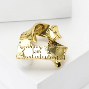 Creative gold tape measure brooch for women with vintage matte finish and scale markings