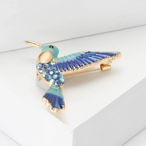 Elegante spilla a colibrì con smalto colorato e strass blu scintillanti su lega