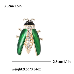 Green beetle brooch with rhinestones and enamel on a gold-plated metal base