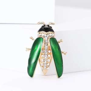 Elegant gold alloy ladybug brooch with green enamel wings and sparkling rhinestones