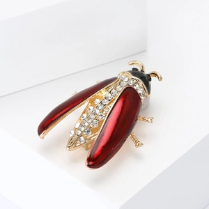 Elegant beetle brooch with red enamel wings and sparkling zircons in gold finish