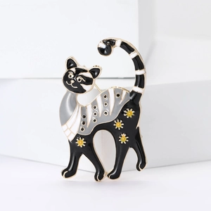 Detail view of cartoon cat enamel brooch with yellow flowers and white stripes