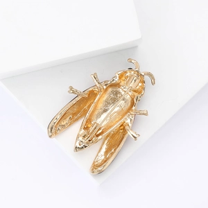 Detailed back view of a golden beetle brooch featuring a secure rotating pin clasp closure