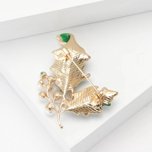 Vue arrière de la broche feuille dorée avec émail, perle et fermoir à épingle sécurisé