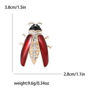 Elegant ladybug brooch with red enamel wings and sparkling crystals on a gold base