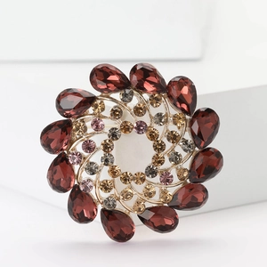 Elegant gold alloy flower brooch with red crystals and rhinestone spiral design