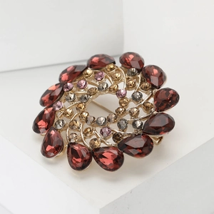 Elegant spiral flower brooch with deep red crystals on a gold alloy base for women