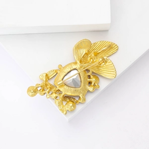 Detail view of gold alloy butterfly brooch back showing crystal setting and pin clasp