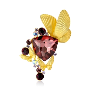Elegant gold butterfly brooch with large faceted purple crystal and colorful rhinestones